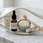 Ultra close-up macro of minimalist travel toiletries in transparent quart bag on marble vanity