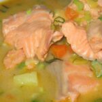 Ultra close-up macro of traditional Finnish salmon soup Lohikeitto with cream and fresh dill in ceramic bowl