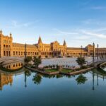 Magnificent Plaza de Espana in Seville Spain with grand palace canal bridges and golden sunlight