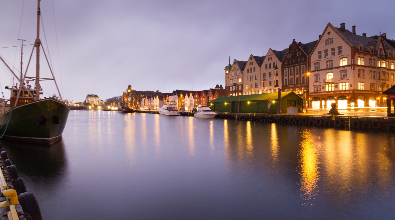 Iconic colorful wooden Hanseatic wharf buildings of Bryggen in Bergen Norway under winter skies