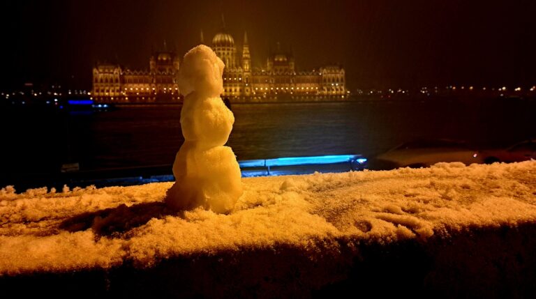 Hungarian Parliament Building illuminated along the Danube River in winter Budapest Hungary