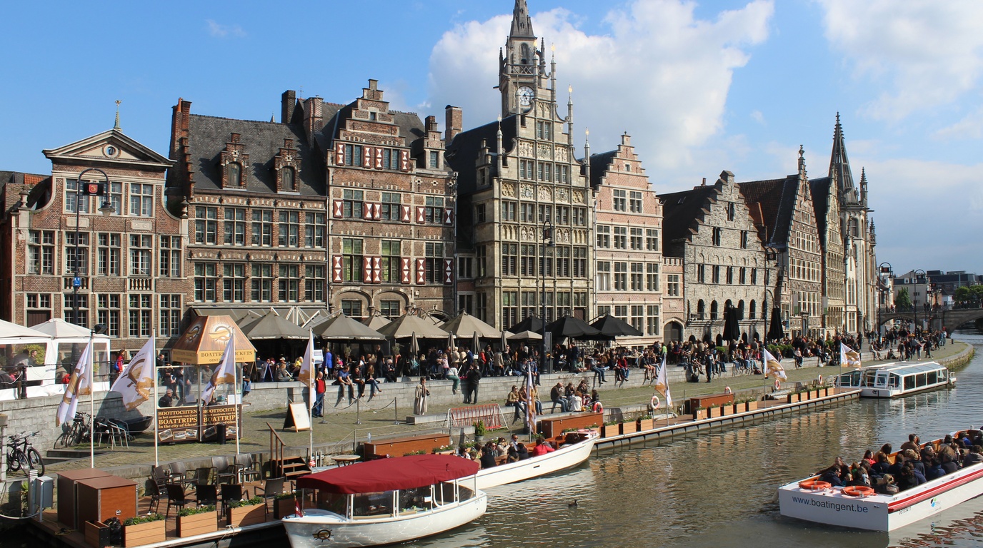 Atmospheric medieval merchant guildhouses along the Graslei canal in Ghent Belgium under winter skies