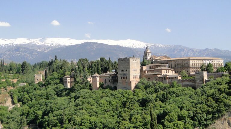 Panoramic view of the Alhambra complex and snow-capped Sierra Nevada mountains in Granada winter