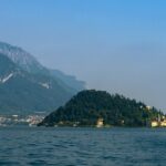 Panoramic view of the Bellagio promontory across the calm blue waters of Lake Como in winter