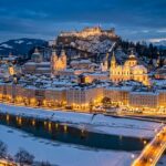 Salzburg Old Town and Hohensalzburg Fortress illuminated at winter twilight