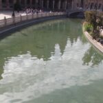Panoramic view of the ceramic bridges and grand pavilion of Plaza de Espana in Seville under warm winter sunshine