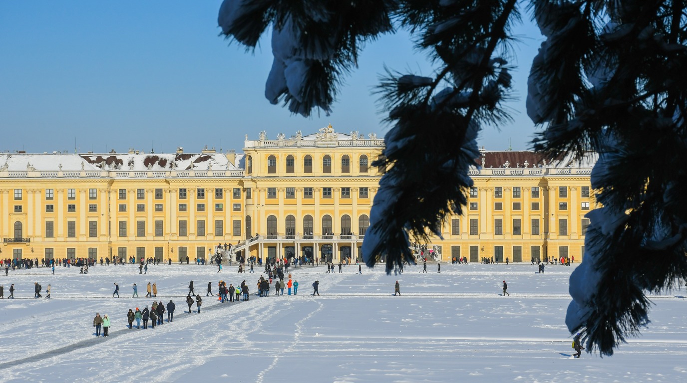 Schönbrunn Palace covered in winter snow with baroque imperial courtyards in Vienna Austria